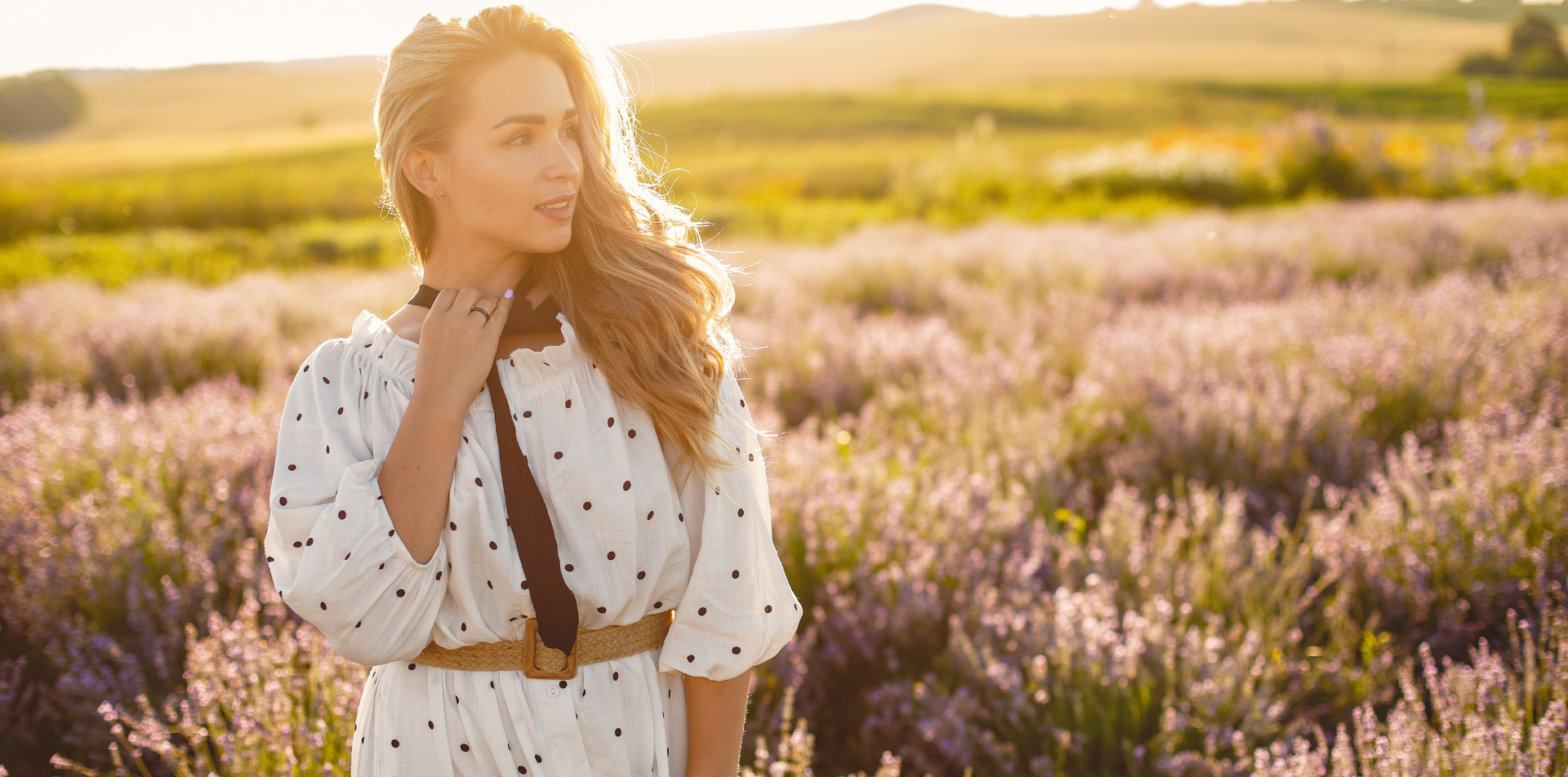 Woman in white floral dress standing in lavender field — Emmie & Ellie women's fashion